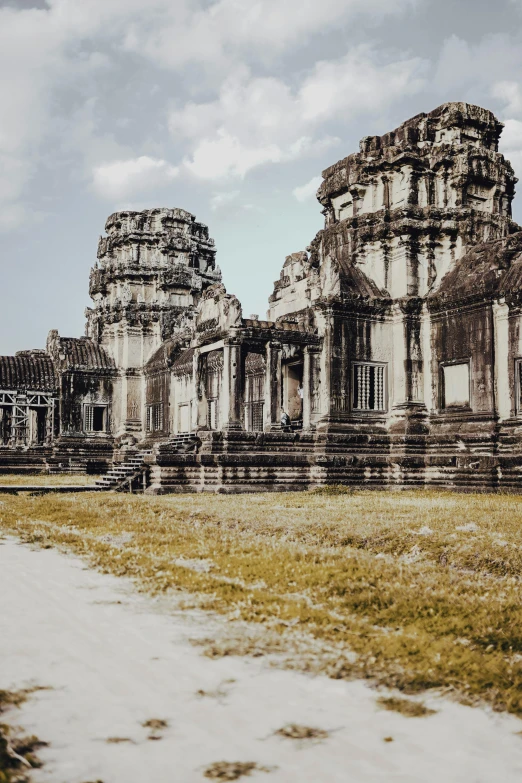 a large stone building sitting on top of a grass covered field, unsplash contest winner, angkor thon, symmetrical details, 4k), instagram story