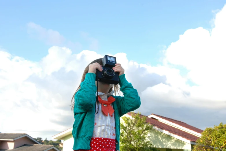 a little girl taking a picture with a camera, inspired by Vivian Maier, unsplash, visual art, blue sky, cardboard pinhole camera, eva elfie, colour hd photography