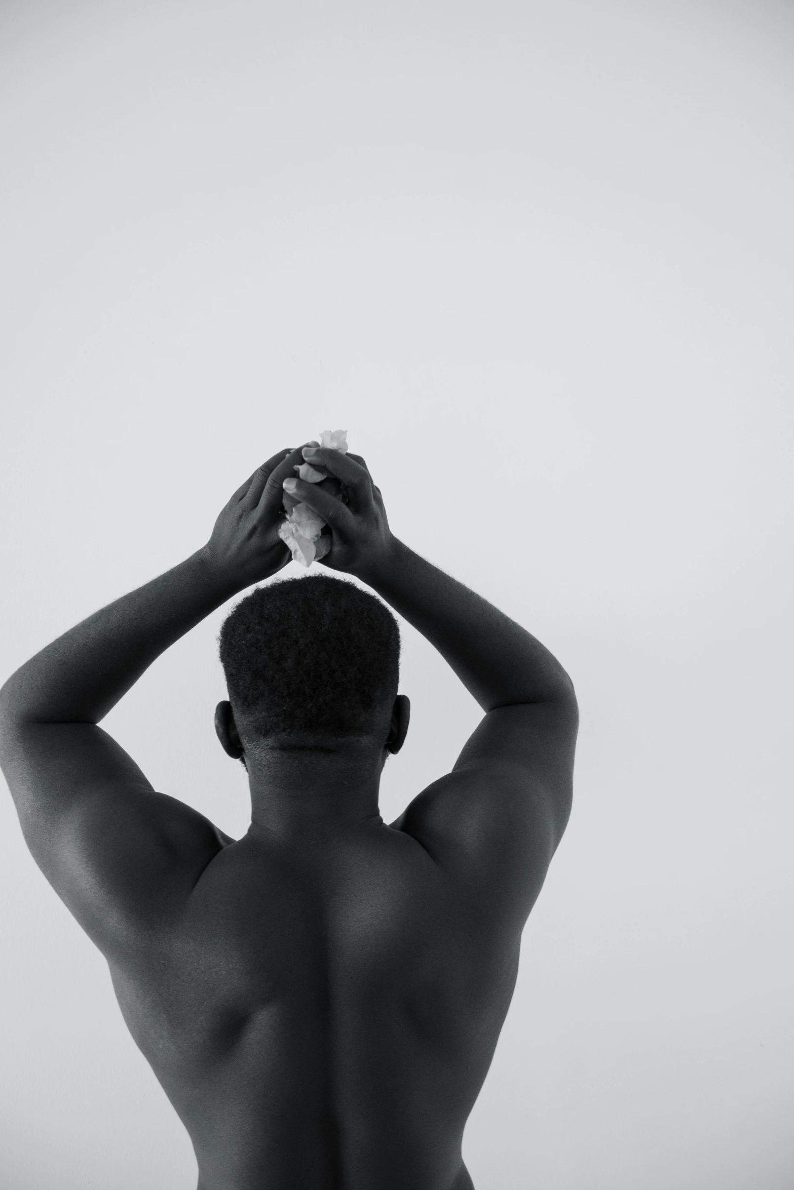 a black and white photo of a naked man, a black and white photo, by Clifford Ross, pexels contest winner, scratching head, african american, black main color, video still