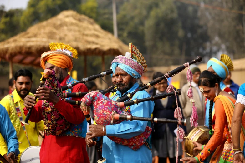 a group of men standing next to each other playing bagpipes, pexels contest winner, hurufiyya, colourful clothing, avatar image, uttarakhand, thumbnail