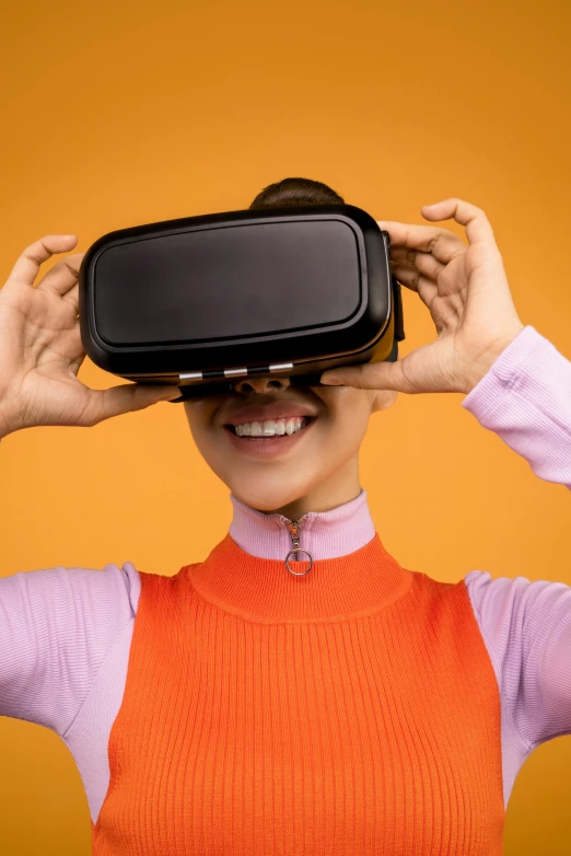 a woman is wearing a virtual reality headset, shutterstock, hypermodernism, in front of an orange background, square, trending on mentalray, electronics