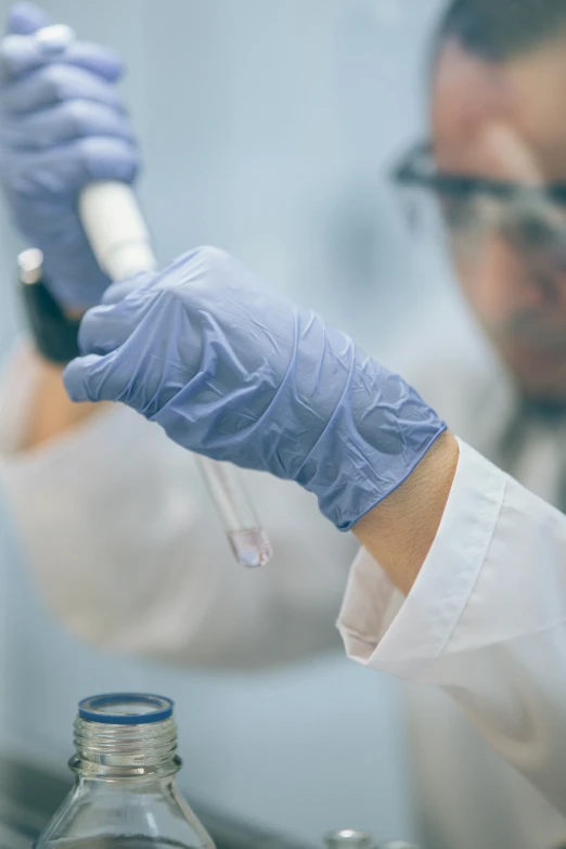 a man in a lab coat holding a test tube, shutterstock, wearing gloves, instagram post, splash image, a wide shot