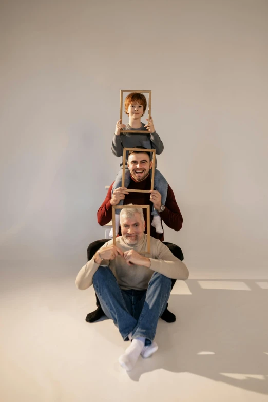a group of people sitting on top of each other, an album cover, by Attila Meszlenyi, pexels contest winner, conceptual art, picture frames, three dwarf brothers, in a photo studio, four faces in one creature