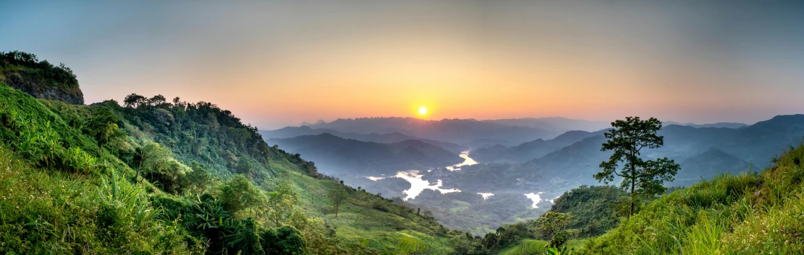 a river running through a lush green valley, an album cover, pexels contest winner, sumatraism, sunset panorama, guangjian, winter sun, sri lankan landscape