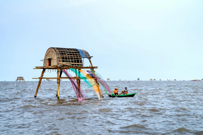 a water slide in the middle of a body of water, by Jan Tengnagel, pexels contest winner, environmental art, bamboo huts, guwahati, on stilts, dezeen