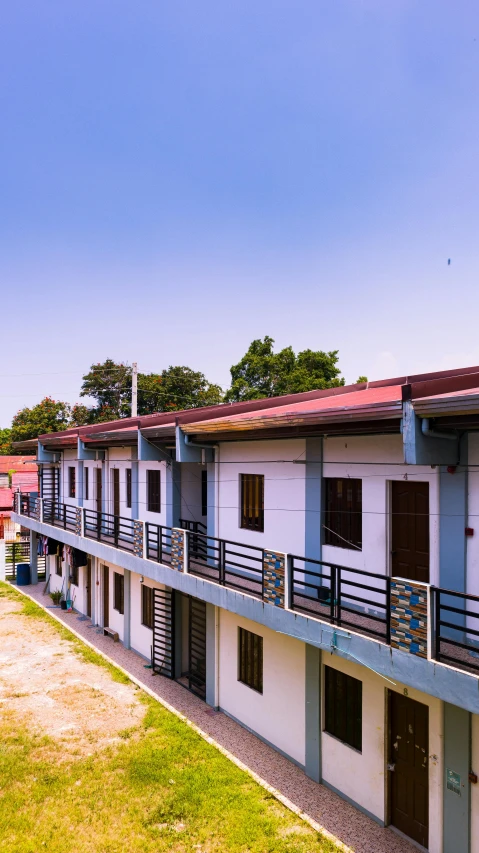 a couple of buildings that are next to each other, inspired by Genco Gulan, shutterstock, philippines, school courtyard, slide show, small town