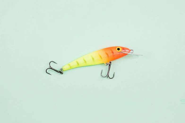 a close up of a fishing lure on a white surface, a digital rendering, trending on pexels, gradient yellow to red, neon pastel, a wooden, product introduction photo
