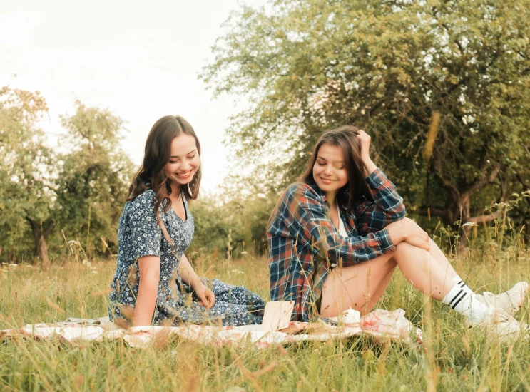 two women sitting on a blanket in a field, pexels contest winner, isabela moner, having a picnic, avatar image, college girls