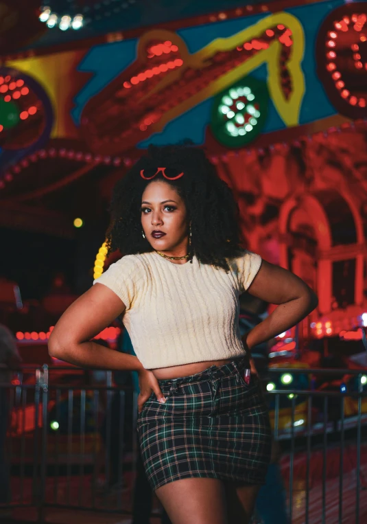 a woman standing in front of a carousel at night, an album cover, trending on unsplash, kitsch movement, alluring plus sized model, woman in streetwear, black teenage girl, multicoloured