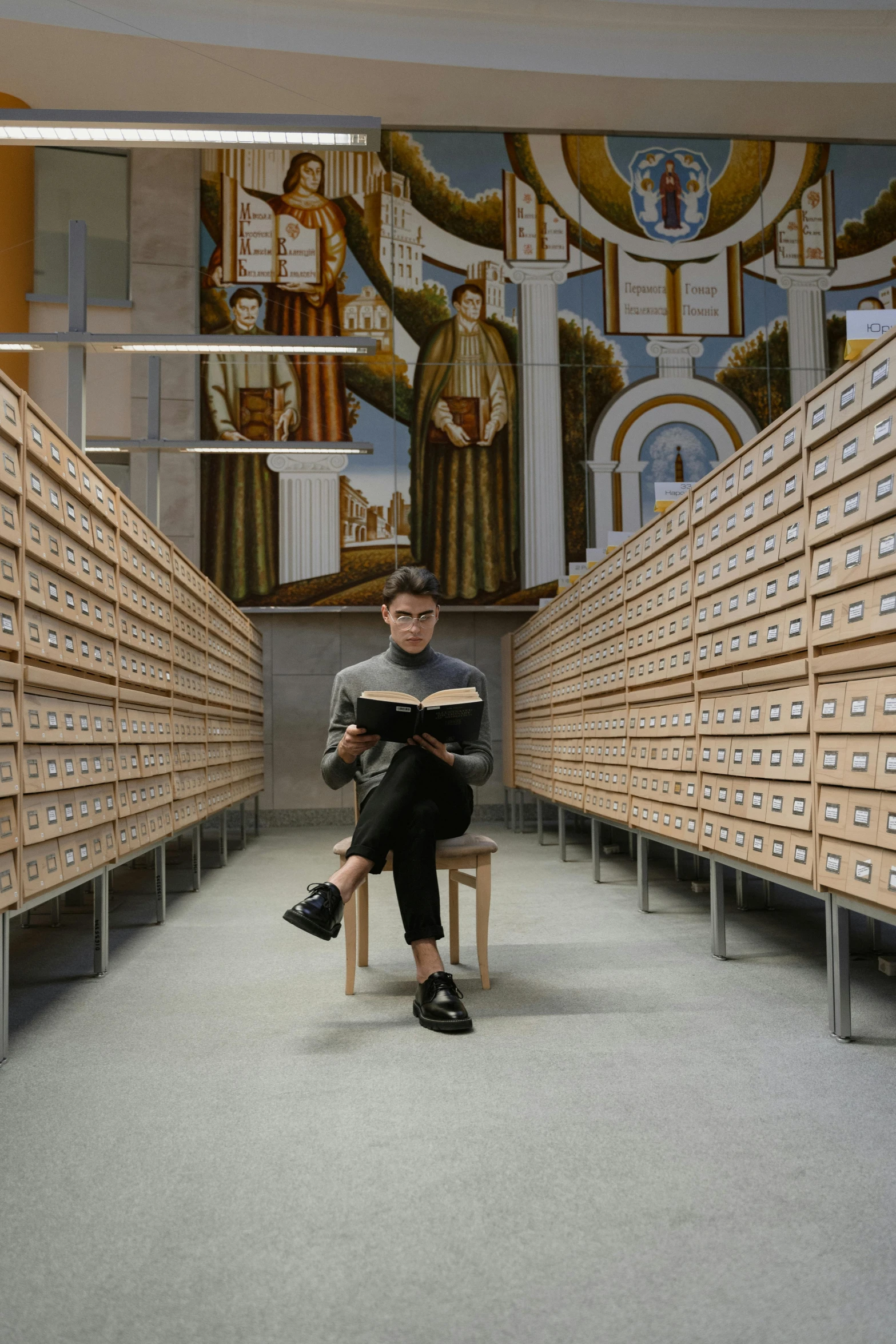 a man sitting on a chair reading a book, inspired by Fei Danxu, academic art, in a large cathedral, non-binary, government archive, italy