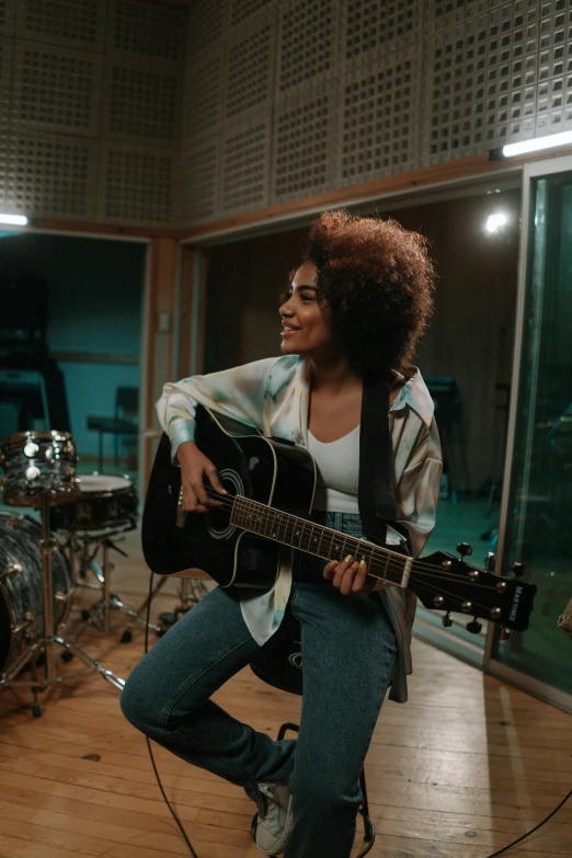 a woman playing a guitar in a recording studio, happening, imaan hammam, about to step on you, ameera al-taweel, promotional image