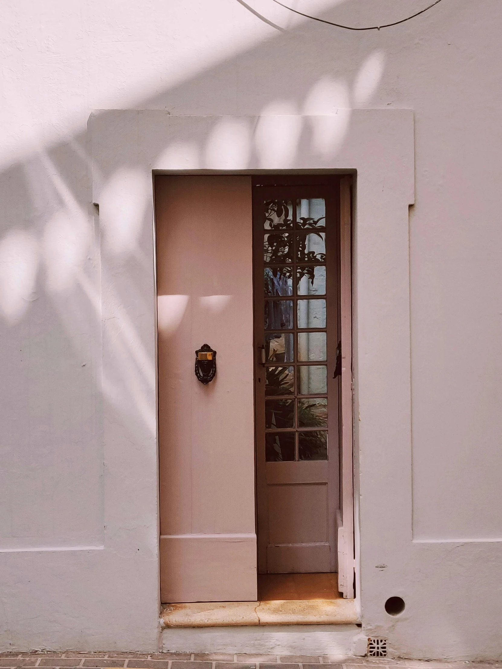 a red fire hydrant sitting in front of a white building, by Carey Morris, pexels contest winner, light and space, pink door, contre jour, colonial style, exiting from a wardrobe