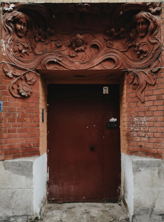 a red door in front of a brick building, inspired by Elsa Bleda, pexels contest winner, art nouveau, buildings covered with greebles, фото девушка курит, candid photograph, black and terracotta