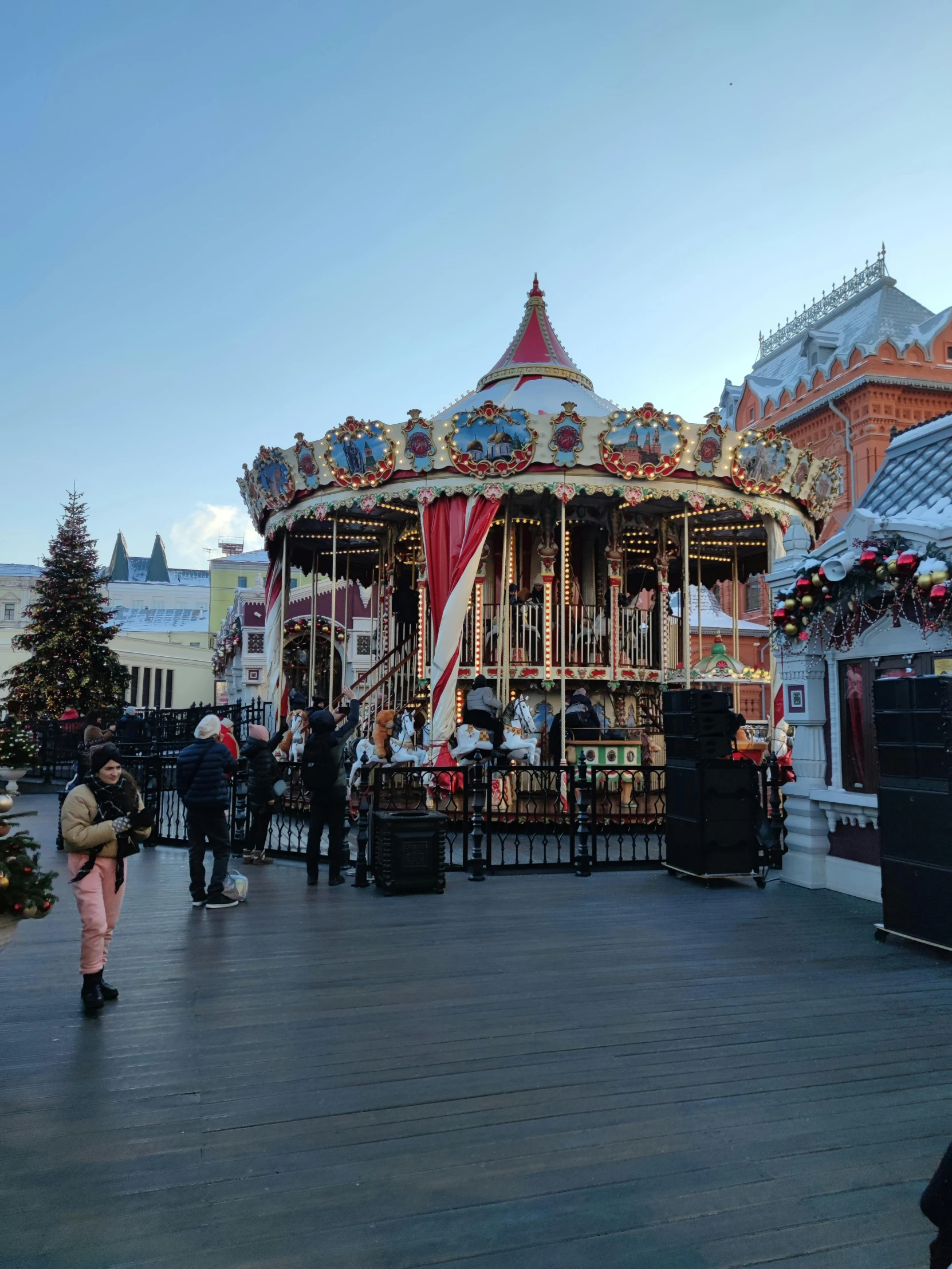 a group of people standing in front of a carousel, holiday season, 🚿🗝📝, 000 — википедия, beautiful environment