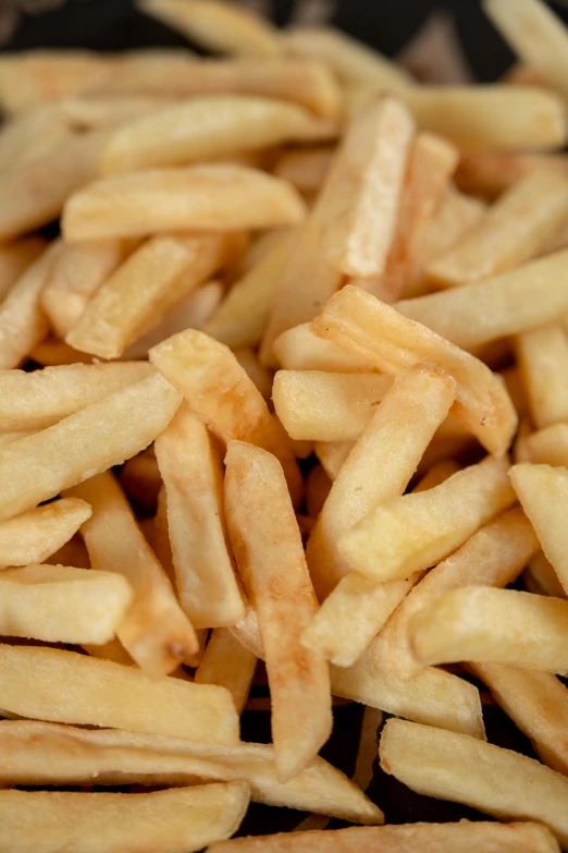 a pile of french fries sitting on top of a table, zoomed out shot, 64x64, vanilla, up close image