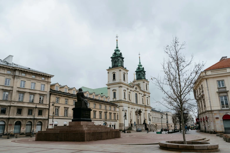 a large building with a statue in front of it, a statue, by Emma Andijewska, baroque, lead - covered spire, square, 1 petapixel image