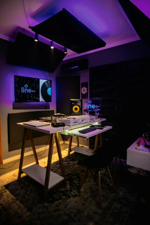 a room with a desk and speakers in it, by Robbie Trevino, lyco art, green and purple studio lighting, turntablist, innate studio, high quality photo