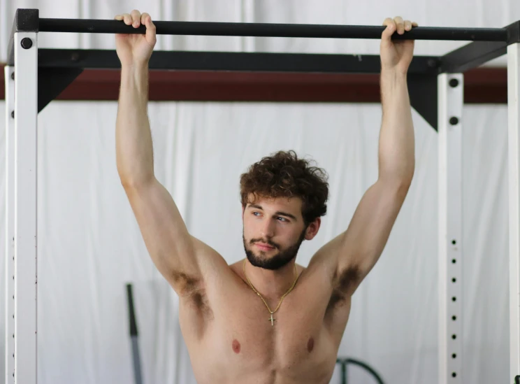 a shirtless man doing pull ups on a pull up bar, a portrait, by Alexis Grimou, pexels contest winner, arabesque, khabib, avatar image, diana levin, low quality photo