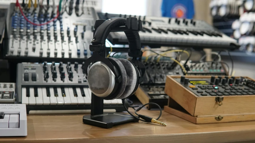 a pair of headphones sitting on top of a desk, private press, synthesizers, headphone stand, thumbnail, portrait n - 9