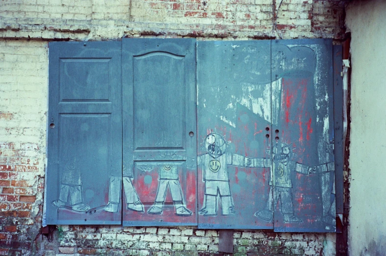 a painting on the side of a brick building, unsplash, street art, metal robots, 1970s photo, 3 doors, vintage color photo