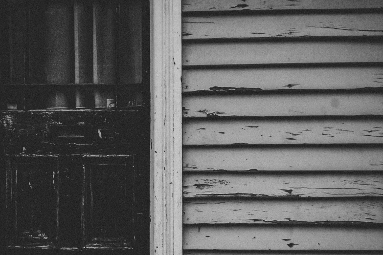 a black and white photo of a wooden door, inspired by Arnold Newman, pexels contest winner, photo of poor condition, horror wallpaper aesthetic, background image, house windows