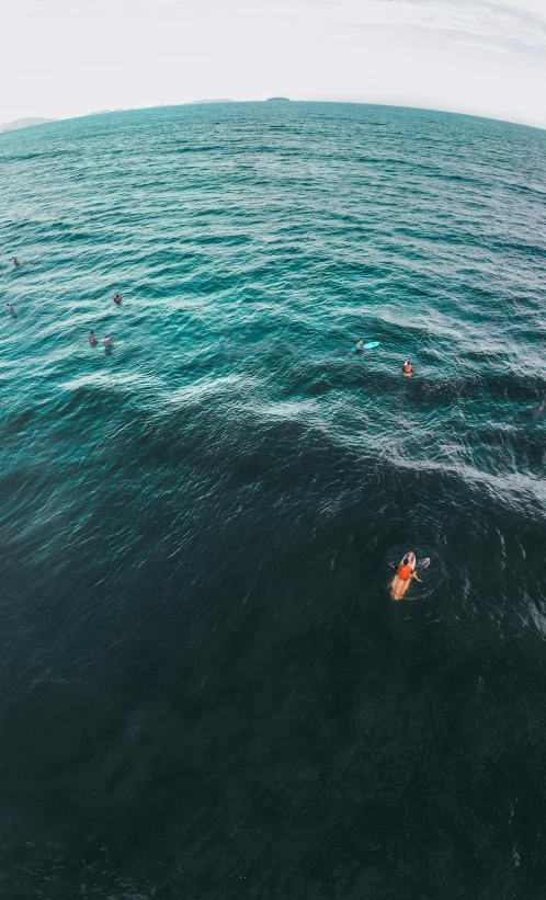 a man riding a wave on top of a surfboard, by Robbie Trevino, unsplash contest winner, drone wide shot, crowded, manly, calm sea