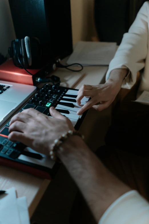 a close up of a person typing on a keyboard, an album cover, inspired by Elsa Bleda, pexels, in his basement studio, musicians playing instruments, scientific study, medium shot portrait