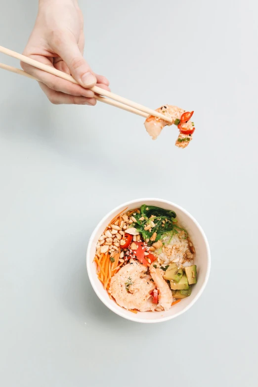 a person holding chopsticks over a bowl of food, square, white bg, prawn, from street level