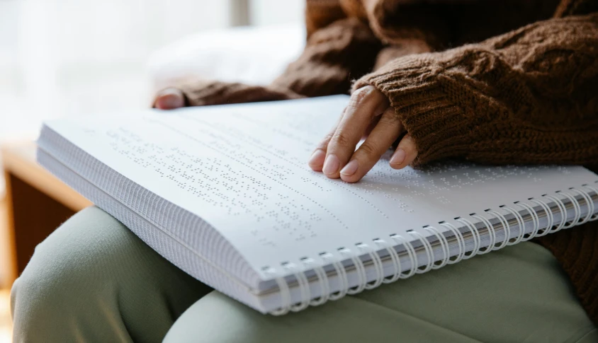 a close up of a person holding a book, on a notebook page, sitting down, erak note, dotting