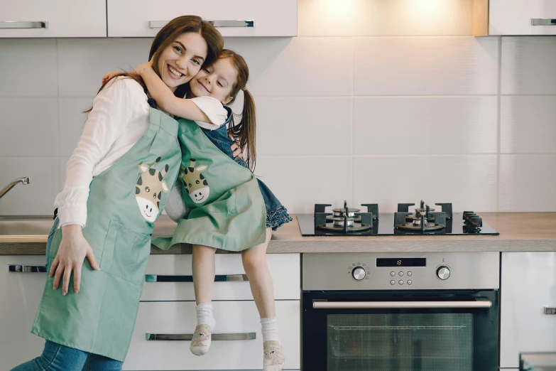 a woman holding a little girl in a kitchen, painted overalls, 15081959 21121991 01012000 4k, australian, high-quality photo