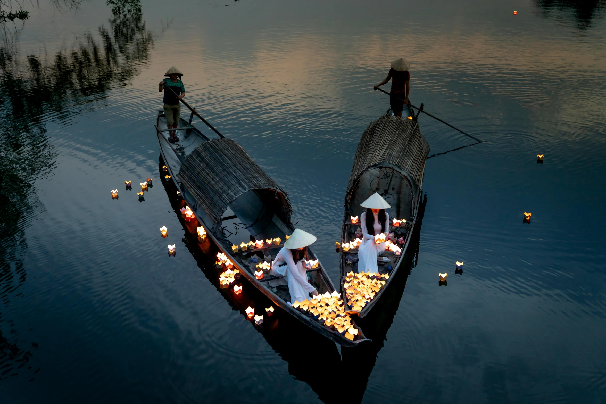 a couple of boats that are sitting in the water, inspired by Steve McCurry, unsplash contest winner, conceptual art, floating candles, ao dai, ignant, late summer evening