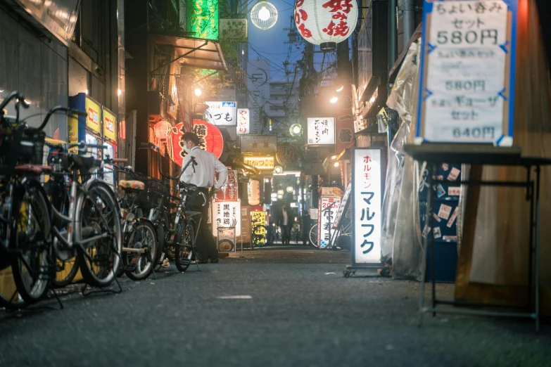 a street filled with lots of bikes next to tall buildings, a photo, unsplash contest winner, ukiyo-e, dimly lit dive bar, 🚿🗝📝