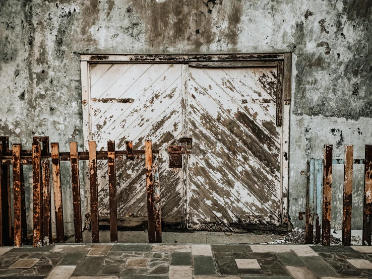 a white door sitting next to a wooden fence, by Lucia Peka, pexels contest winner, post apocalyptic room interior, rusty metal towers, grungy; colorful, background image