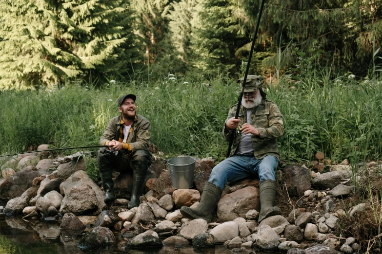 a couple of men sitting on top of a rock next to a river, fish man, overalls and a white beard, avatar image, jovana rikalo