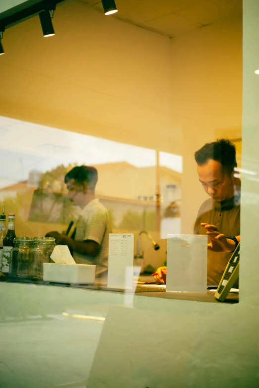 a couple of men standing next to each other in a kitchen, a picture, unsplash, process art, miniature cafe diorama, reflections. shady, ignant, loish and ross tran