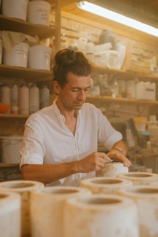 a man working on pottery in a pottery shop, a portrait, inspired by Hendrik Gerritsz Pot, pexels contest winner, organic ceramic white, australian, made of glazed, profile picture