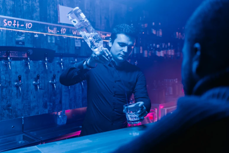 a man that is standing in front of a bar, pouring, epic cold blue lighting, pulling the move'the banshee ', club photography