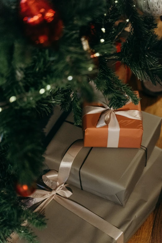 a pile of presents under a christmas tree, pexels contest winner, orange ribbons, grey, thumbnail, opening shot