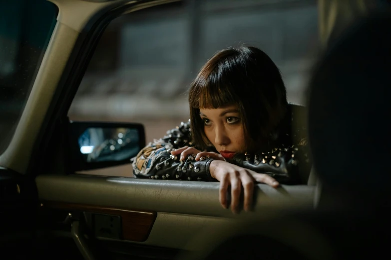 a woman looking out the window of a car, an album cover, inspired by Elsa Bleda, trending on pexels, hyperrealism, park shin hye as a super villain, blunt bangs fall on her forehead, kiko mizuhara, 7 0 mm. dramatic lighting