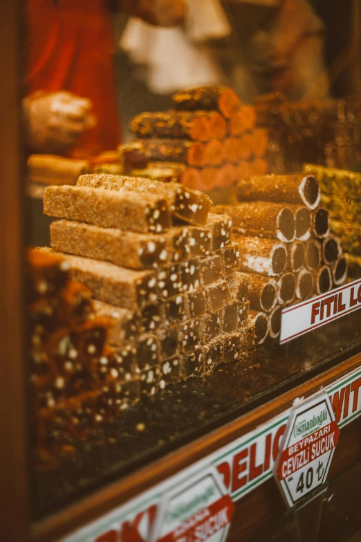 a display case filled with lots of different types of food, a tilt shift photo, trending on pexels, art nouveau, cigars, caramel, profile image, 1 7 8 0