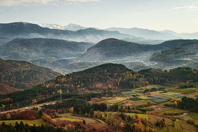 a view of a valley with mountains in the background, by Cedric Peyravernay, pexels contest winner, cloicsonne, gunma prefecture, dezeen, 8k resolution”