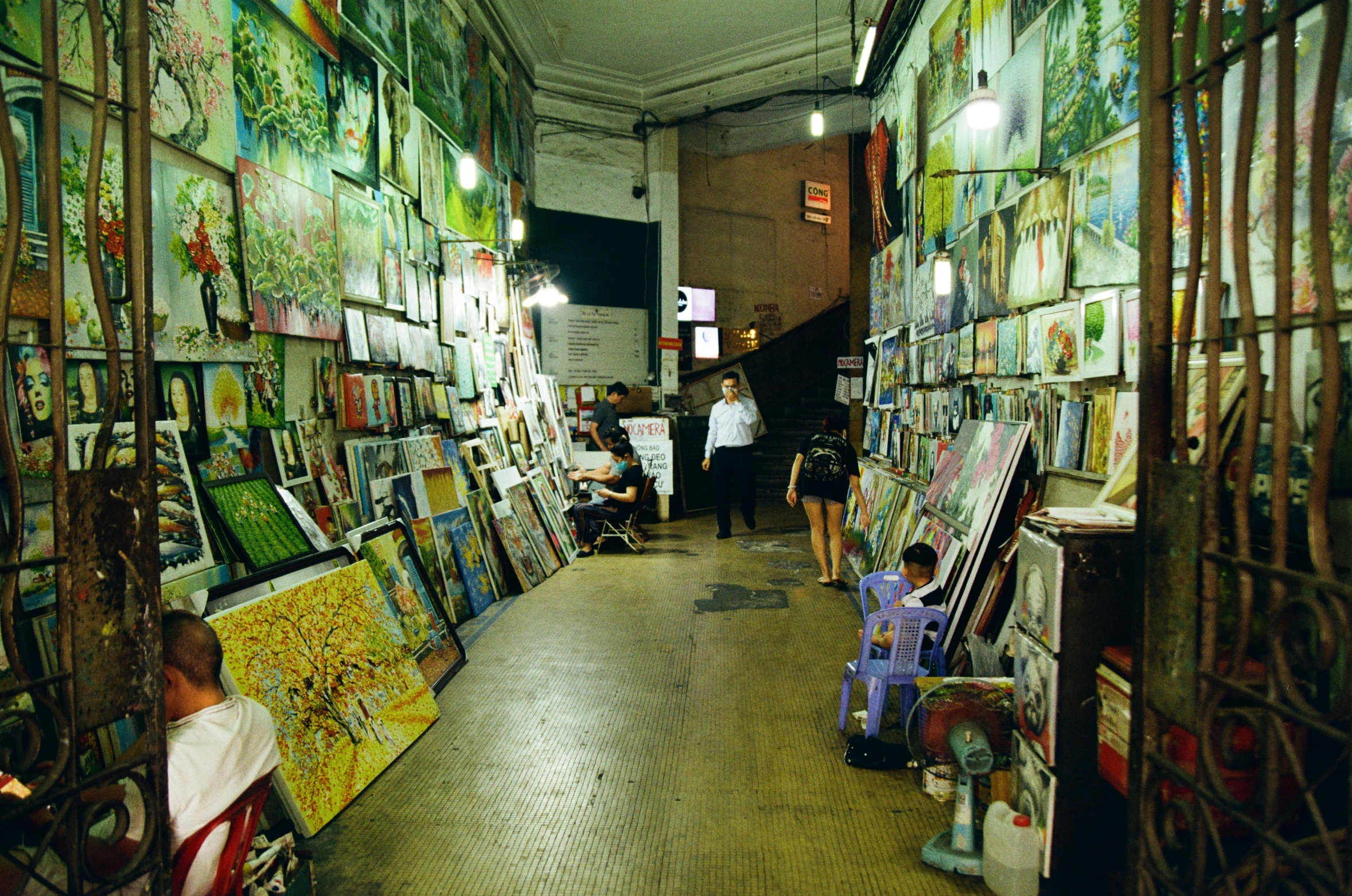 a room filled with lots of paintings and people, flickr, wet market street, 2000s photo, fan favorite, green alley