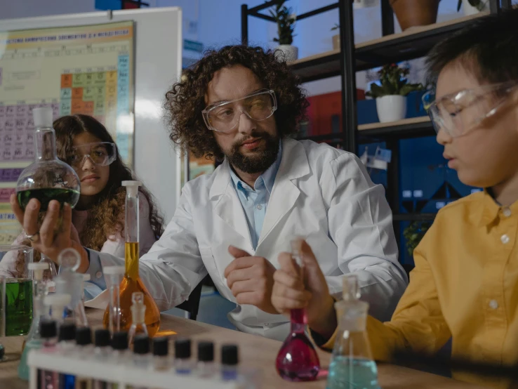 a group of people sitting around a table in a lab, pexels, analytical art, fan favorite, giorgio a. tsoukalos, inspect in inventory image, fluids