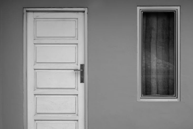 a black and white photo of a door and a window, by Jan Kupecký, pexels contest winner, postminimalism, in style of simplified realism, soft colors mono chromatic, half image, semi realism