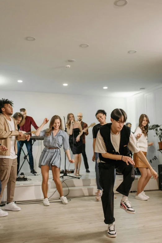 a group of people that are standing in a room, an album cover, trending on pexels, he is dancing, high quality photo, performance, australia