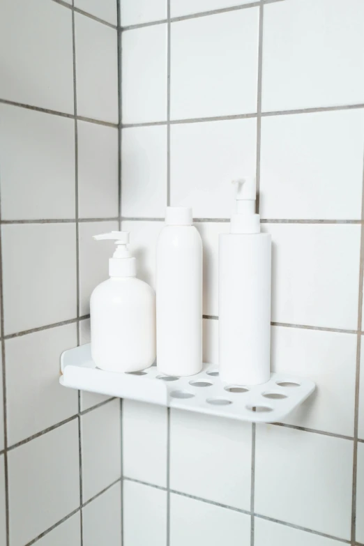 a bath room with a toilet a sink and a soap dispenser, by Andries Stock, stacking supermarket shelves, 3 colours, 8l, white