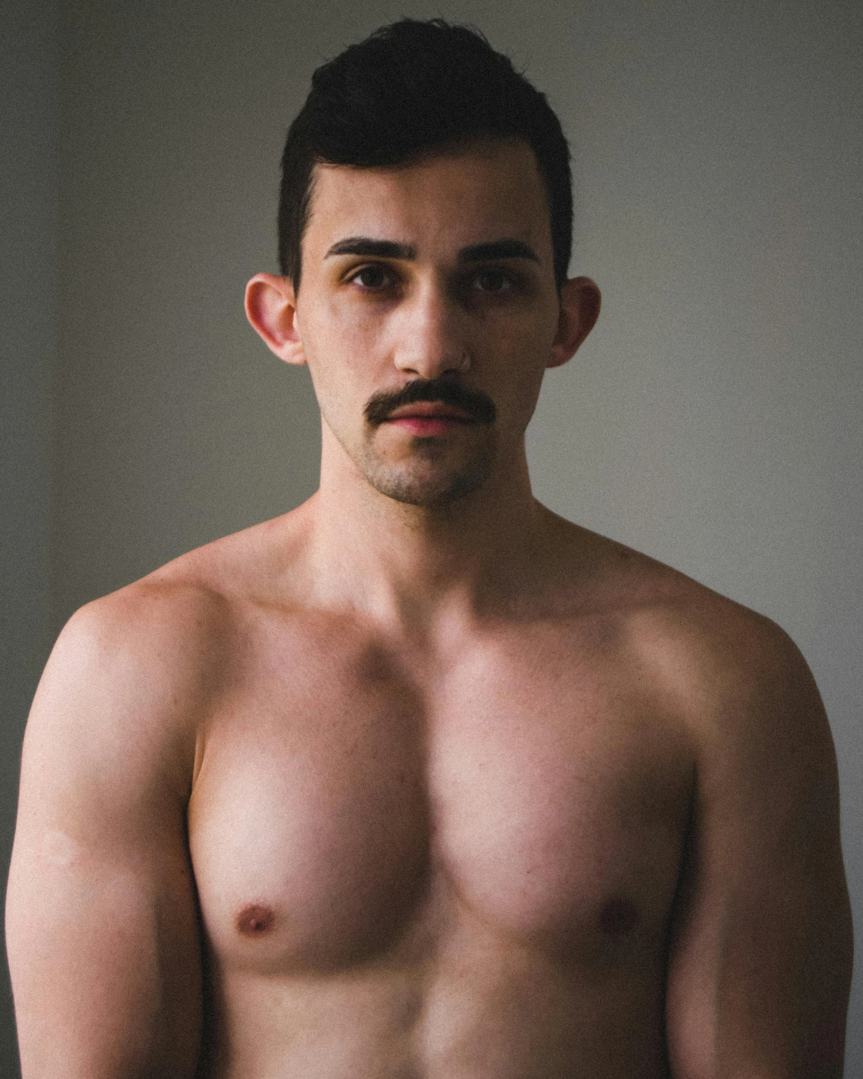 a shirtless man standing in front of a window, by Jessie Alexandra Dick, trending on unsplash, mexican mustache, nonbinary model, real life photo of a syrian man, made of flesh and muscles