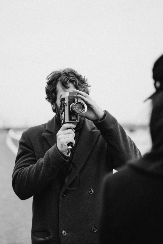 a man taking a picture of another man with a camera, a black and white photo, unsplash, visual art, will graham, tom burke, gentleman, hozier