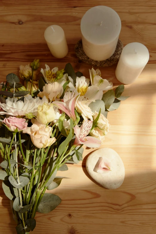 a bunch of flowers sitting on top of a wooden table, heavenly marble, with soft pink colors, softly lit, soothing