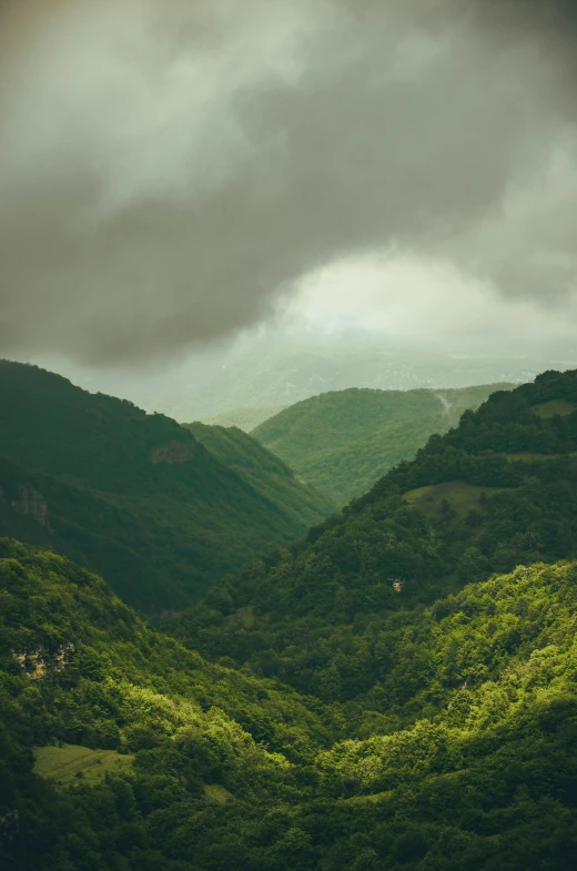 a view of the mountains from the top of a hill, by Muggur, pexels contest winner, les nabis, muted green, thunderclouds, georgic, malibu canyon